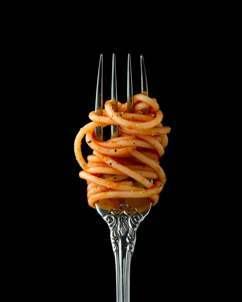 Spaghetti in tomato sauce twirled on a fork