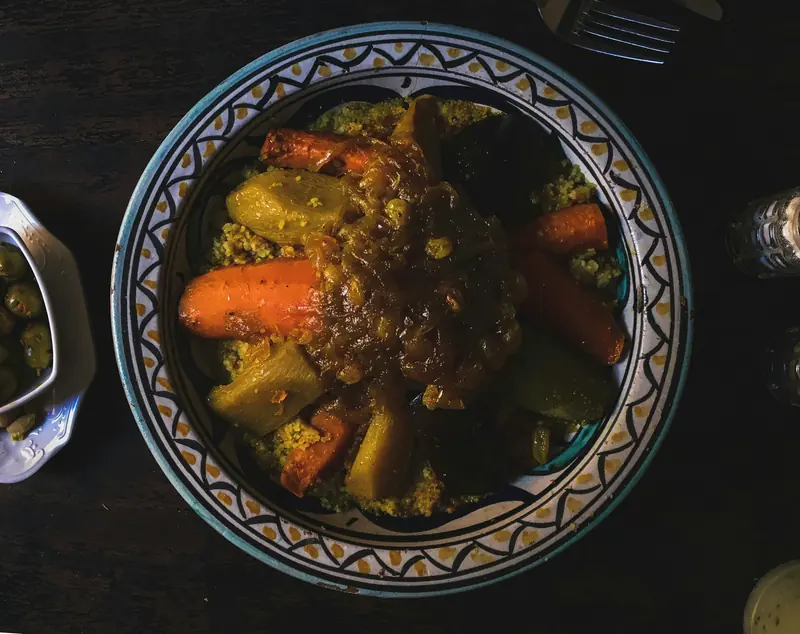 A Moroccan tagine with vegetables in a patterned dish
