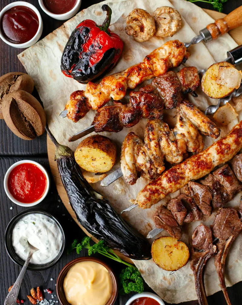 A Turkish grill board with kebabs, skewers and charred vegetables